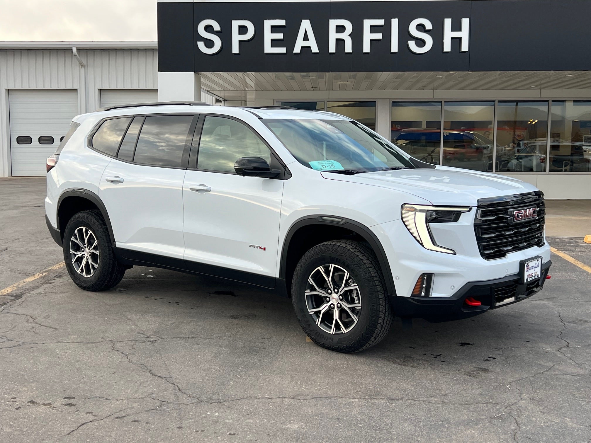 2026 GMC Acadia AT4 in Glacier White Tricoat — front three-quarter view