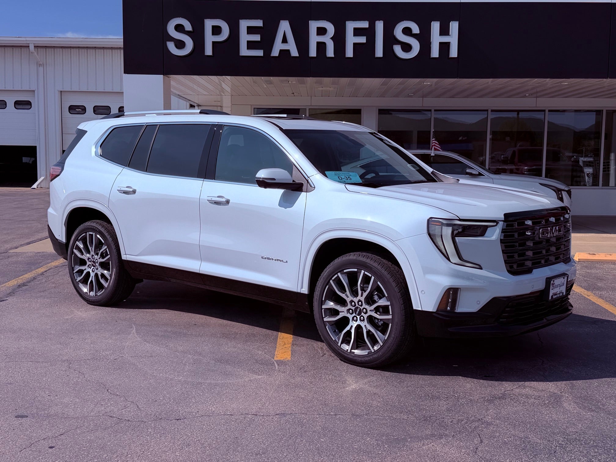 2026 GMC Acadia Denali Ultimate in Glacier White Tricoat — front three-quarter view
