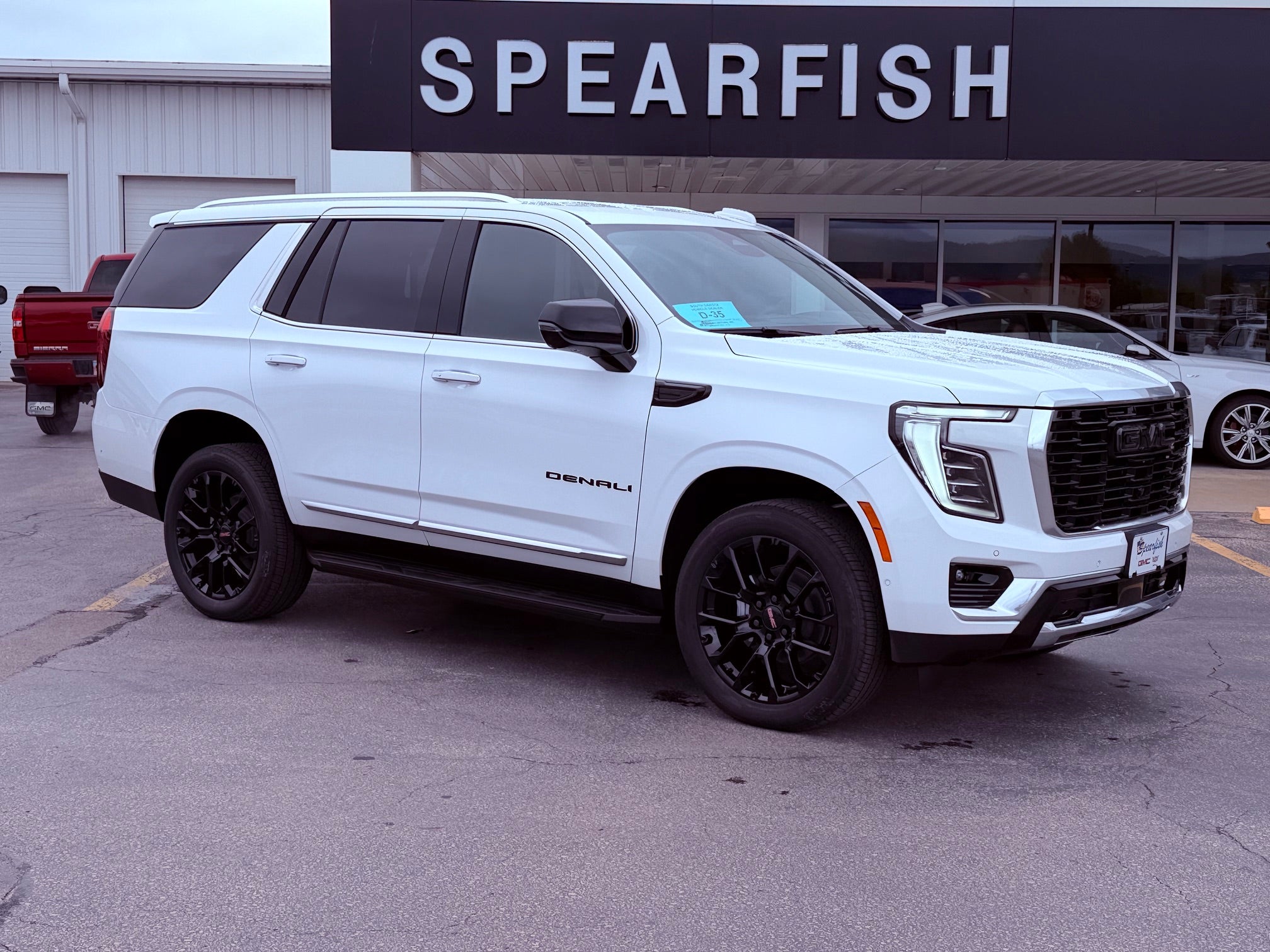 2026 GMC Yukon Denali in Summit White — front three-quarter view
