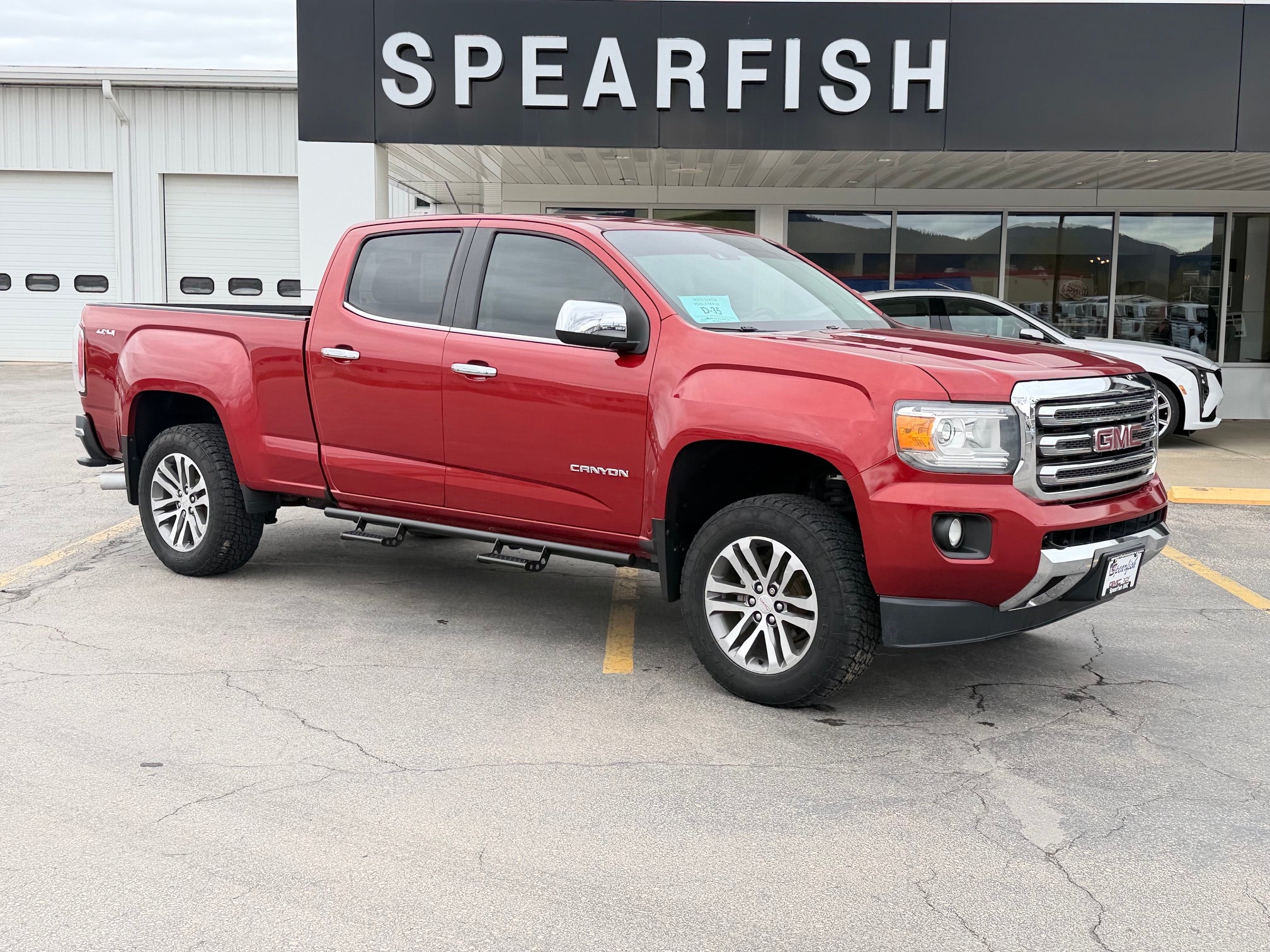 2016 GMC Canyon Crew Cab Long Box 4-Wheel Drive SLT in Copper Red Metallic — front three-quarter view